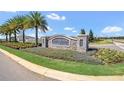 Stone monument sign at Overlook at Grassy Lake with flower beds and manicured landscaping at 3054 Hill Point St, Minneola, FL 34715
