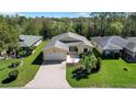 An aerial view showcasing this home's spacious lawn, well-kept landscaping, and prime corner lot location at 341 Ranchwood Dr, Leesburg, FL 34748