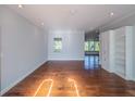 Bright living room with hardwood floors, built-in shelving, and plenty of natural light at 351 Groveland Rd, Mount Dora, FL 32757