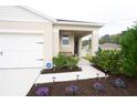 Inviting front porch with bench, manicured flower beds, and walkway with garden lights at 412 Lady Bella Pl, Deland, FL 32724