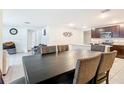 Spacious dining area adjacent to the kitchen with a large dark table and cushioned chairs at 4923 Sw 166Th Loop, Ocala, FL 34473
