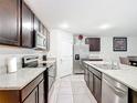 Modern kitchen with stainless steel appliances, granite countertops, and dark cabinetry at 4923 Sw 166Th Loop, Ocala, FL 34473