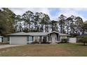 Charming single-story home with a manicured lawn, two-car garage, and inviting front entrance at 505 Hamlet Ct, Fruitland Park, FL 34731