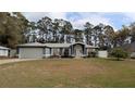 Charming single-story home with a manicured lawn, two-car garage, and inviting front entrance at 505 Hamlet Ct, Fruitland Park, FL 34731