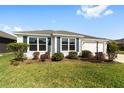 Beautiful one-story home with white siding, green lawn, and inviting curb appeal at 5978 Conley Ct, The Villages, FL 32163