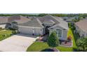 Beautiful single-story home with a spacious two-car garage, well-maintained lawn, and charming front entrance at 6083 Delphina Loop, The Villages, FL 32163