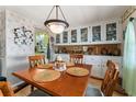 Cozy dining room featuring built-in storage and a classic chandelier at 710 Dolphin Dr, Tavares, FL 32778