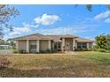 Charming single-story home with a well-manicured lawn and mature landscaping, offering great curb appeal at 7729 Lake Andrea Cir, Mount Dora, FL 32757