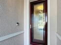 Close up of glass front door with visible Ring doorbell on textured exterior wall at 9113 Sw 91St Court Rd, Ocala, FL 34481