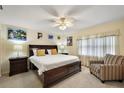 Comfortable main bedroom showcasing a large bed, soft lighting, and relaxing atmosphere at 100 S Tremain St # G1, Mount Dora, FL 32757