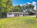 Charming single-story home featuring a well-manicured lawn and attached carport at 1108 Cedar St, Leesburg, FL 34748