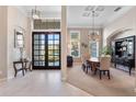 Elegant dining room with high ceilings, chandelier, and large windows offering natural light at 114 Cherry Creek Cir, Winter Springs, FL 32708