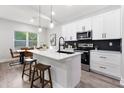 Modern kitchen with white cabinets, stainless steel appliances, and a convenient center island at 12255 Sw 98Th St, Dunnellon, FL 34432