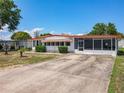 Inviting single-story home with a spacious driveway and lovely curb appeal at 1312 Apache Cir, Tavares, FL 32778