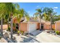 This home boasts a well-manicured lawn, mature palms, and a private two-car garage that is ready for you to move in at 1502 Aalto Pl, The Villages, FL 32159