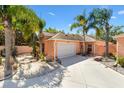 The exterior showcases manicured landscaping, mature palms, and a paver driveway leading to a two-car garage at 1502 Aalto Pl, The Villages, FL 32159