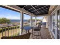 Relax on this cozy balcony overlooking the lake, featuring a table and chairs for outdoor dining at 164 Nautica Mile Dr, Clermont, FL 34711