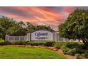 A beautiful community sign for Calumet Grove, surrounded by lush landscaping and colorful flowers at 16721 Se 77Th Northridge Ct, The Villages, FL 32162