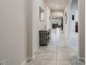 Hallway features tile flooring, neutral paint and leads to the living room at 17024 Goldcrest Loop, Clermont, FL 34714