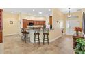 This kitchen features tile floors, an eat-in bar, and updated cabinets at 1797 Pamplico Ct, The Villages, FL 32162