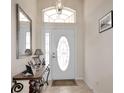 Bright foyer featuring a decorative front door with sidelights and tile flooring at 20751 Queen Alexandra Dr, Leesburg, FL 34748