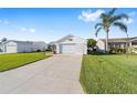 Well-maintained single-story home showcasing a spacious driveway and beautiful green lawn at 2189 Broxton Pl, The Villages, FL 32162