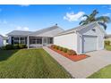 Charming single-story home featuring a well-manicured lawn and a cozy front porch at 2189 Broxton Pl, The Villages, FL 32162