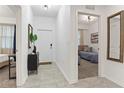 Inviting apartment hallway leading to bedrooms, showcasing modern finishes and tile flooring at 3180 Paradox Circle # 106, Kissimmee, FL 34746