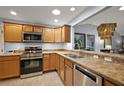 Well-equipped kitchen featuring stainless steel appliances and countertops, and ample cabinet space at 3186 Killington Loop, The Villages, FL 32163