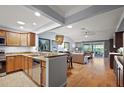 Open-concept kitchen and living room with wood floors and plenty of natural light at 3186 Killington Loop, The Villages, FL 32163