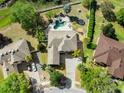 Aerial view showcasing a home with a private pool, well-manicured lawn, and mature trees at 3234 Cypress Grove Dr, Eustis, FL 32736