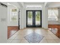 Bright foyer with decorative tile, front door with glass panes, and entry to adjacent rooms at 3234 Cypress Grove Dr, Eustis, FL 32736