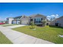 Charming single-story home featuring a well-manicured lawn, neutral paint, and an attached two-car garage at 3719 Holly Grove Ln, Mount Dora, FL 32757