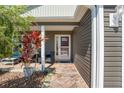 Inviting front porch with comfortable seating area and manicured landscaping, creating a welcoming entrance at 3786 Stephanie Way, The Villages, FL 32163