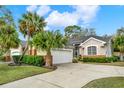 Charming single-story home with a well-manicured lawn and a two-car garage at 39905 Bayview Dr, Lady Lake, FL 32159