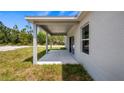 A backyard's covered patio with access to sliding glass doors at 40691 E 9Th Ave, Umatilla, FL 32784