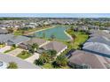 This aerial view displays the property's lakeside setting and the surrounding residential neighborhood at 5835 Hensley Ave, The Villages, FL 32163