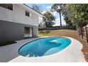 Relaxing in-ground pool surrounded by a concrete patio at 603 N Lakeshore Blvd, Howey In The Hills, FL 34737