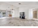 Open living room featuring tile flooring and an open area with sliding glass doors at 11414 Layton St, Leesburg, FL 34788