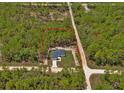 Aerial view showing the home situated on a lot surrounded by lush trees and a defined property boundary at 12444 Sw 76Th Ln, Dunnellon, FL 34432