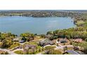 Aerial view of lakefront property featuring a pool, lush landscaping, and private lake access at 16109 Hillside Cir, Montverde, FL 34756