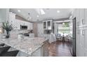 Bright kitchen with granite countertops, white cabinetry, and stainless-steel appliances, blending style and functionality at 16109 Hillside Cir, Montverde, FL 34756