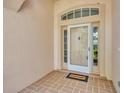 Inviting entryway with decorative brick flooring and a charming front door at 2205 Stonebridge Way, Clermont, FL 34711