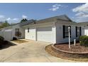 A well-maintained home featuring a one car garage, white siding, and neatly landscaped yard at 2238 Pilar Pl, The Villages, FL 32162