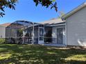 Enjoy outdoor living on the screened patio with neutral patio finish and exterior door access at 24614 Stillridge Ct, Leesburg, FL 34748