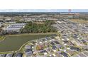 Expansive aerial view of a residential community near a lake and commercial area at 2919 Monument Way, The Villages, FL 32163