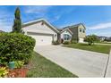 Well-manicured lawn, attached garage, and an inviting exterior provide this house with curb appeal at 3646 Maidencain St, Clermont, FL 34714