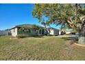 A well-maintained home with mature trees, lush green lawn and landscaping at 410 Majestic Gardens Blvd, Winter Haven, FL 33880