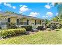 Charming one-story home with manicured lawn, complemented by lush bushes and a vibrant green lawn at 450 Liberty Ave # 3, Mount Dora, FL 32757