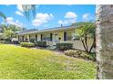 Charming one-story home with manicured lawn, complemented by lush bushes and a vibrant green lawn at 450 Liberty Ave # 3, Mount Dora, FL 32757